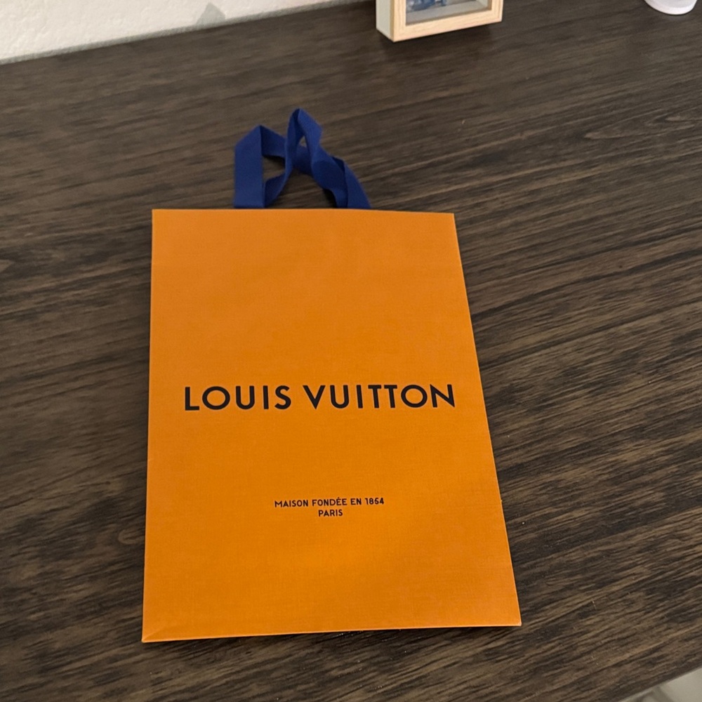 Louis Vuitton Vibrant Orange Shopping paper bag with Blue Handle.
